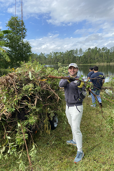 UNF Swoop Into Service volunteer holding a tree