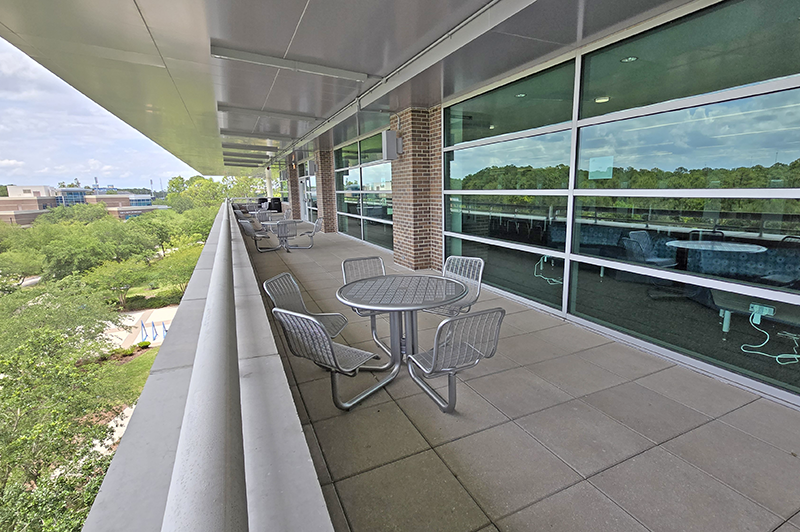 Outside view of the UNF library 4th floor balcony with tables