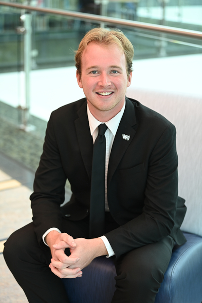 UNF Student Body President Michael Barcal seated in the campus library