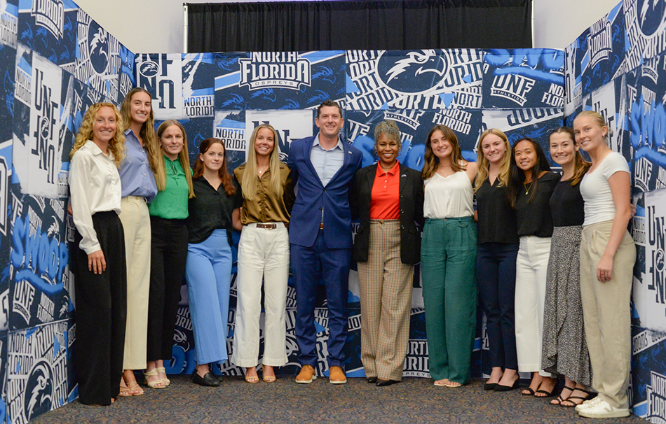 UNF athletes taking a photo at the UNF Women's STEM and Athletics Scholarship Luncheon event