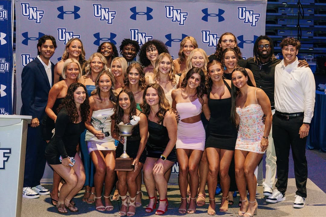 Group of UNF student-athletes posing at a formal event