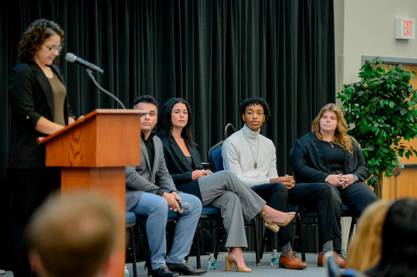 UNF students seated on stage at a panel discussion