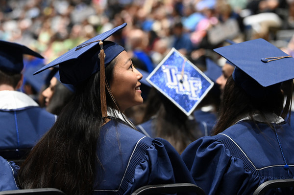 UNF students seated at commencement wearing caps and gowns