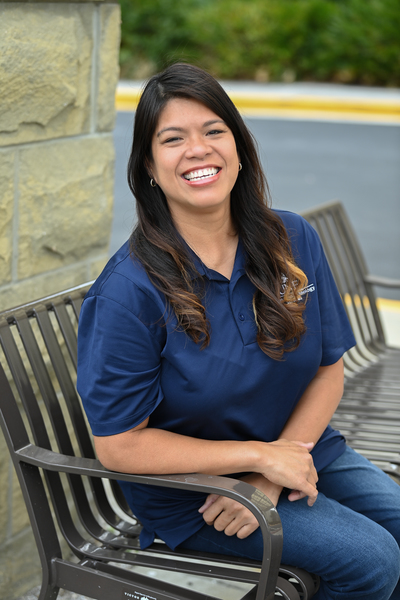 Jennifer Mendoza seated outside of UNF Hicks Hall