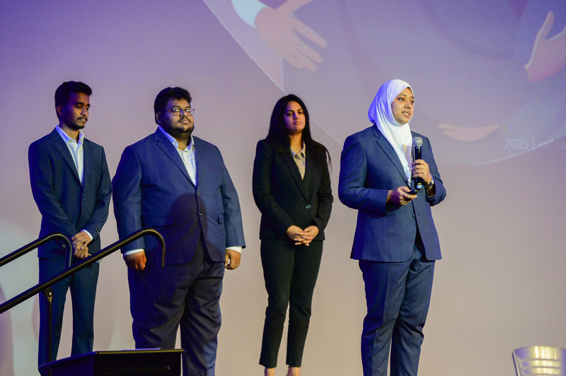 Group of students on stage presenting their research project