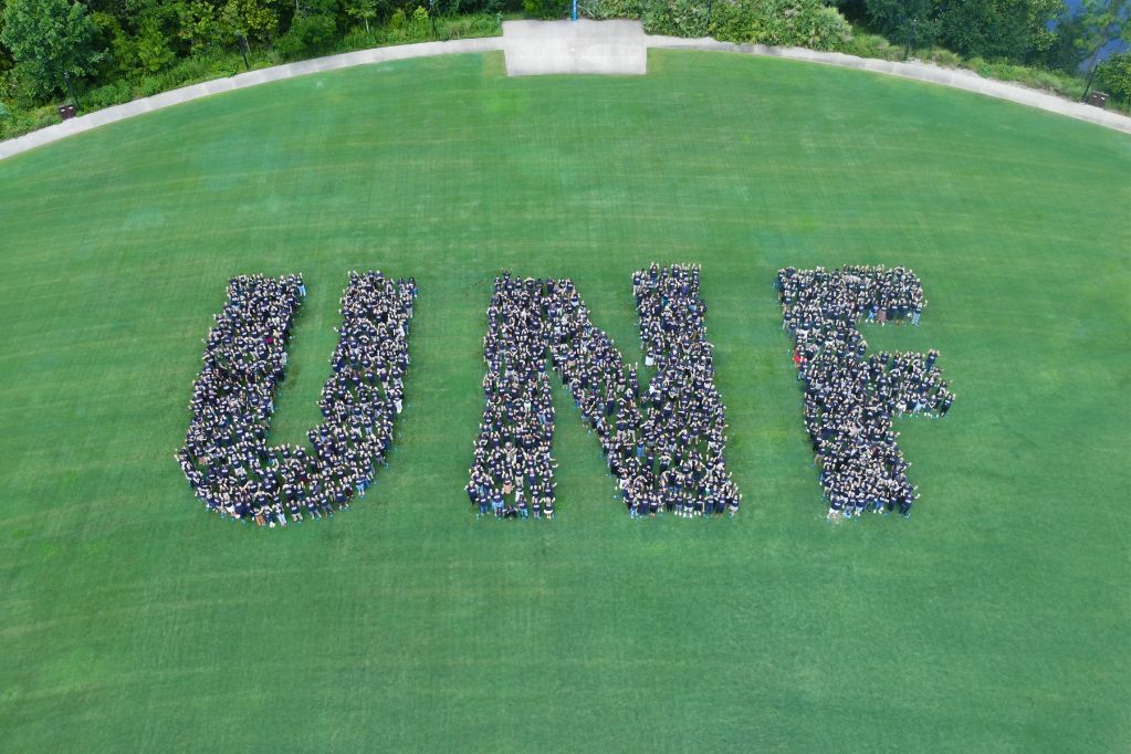 UNF employees gathered in formation spelling U-N-F