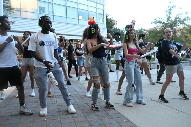 Group of UNF students dancing in the student union plaza
