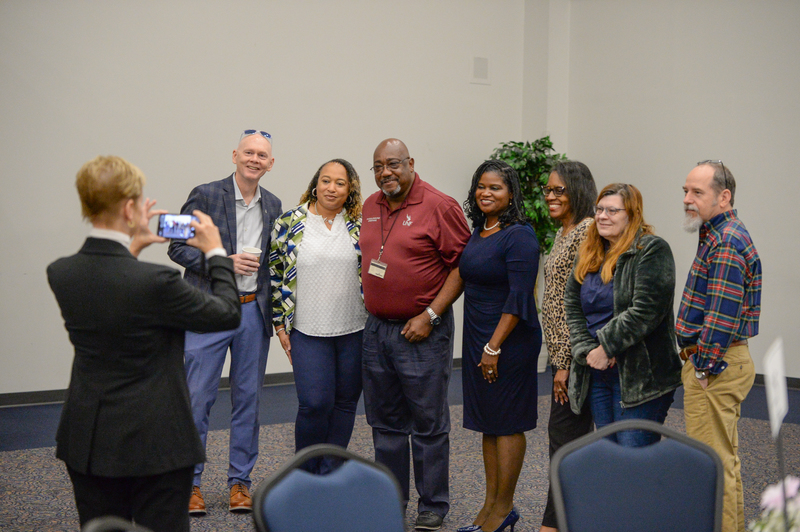 Group of UNF employees at an event posing for a picture