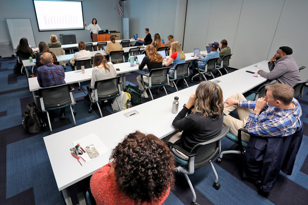 UNF students sitting at desks listening to a professor