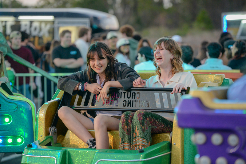 Two female UNF student laughing on a carnival ride