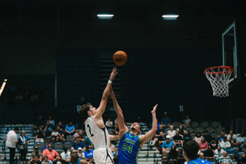 UNF basketball player shooting a shot over an opponent