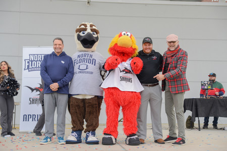 President Limayem with Ozzie and Jax Sharks mascot and employees