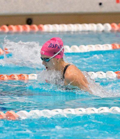 UNF swim team member swimming in the pool