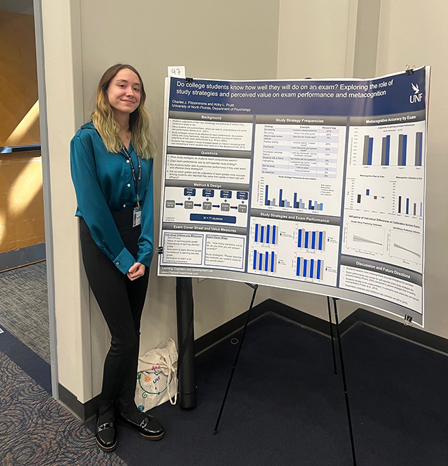 Abby Pruitt posing next to her research poster