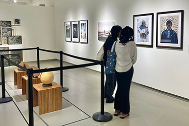 Two women looking at a museum exhibition