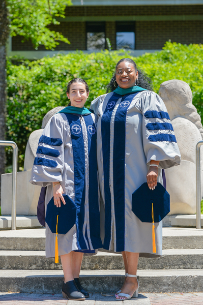 Gianna Forte and Shekinah Mitchell in holding their caps
