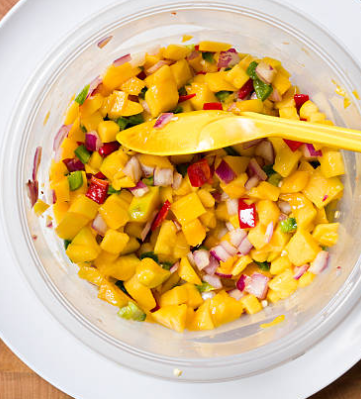 mango salsa in a bowl with a spoon