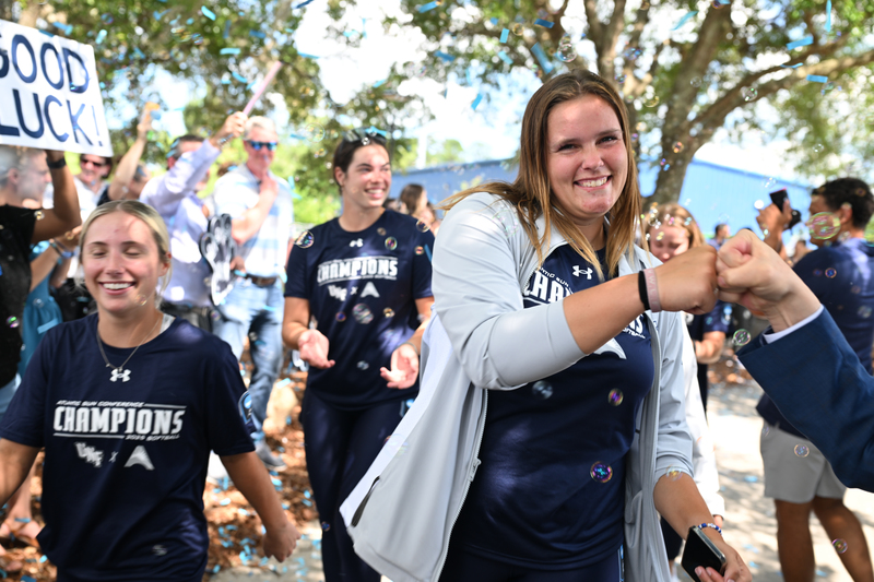 Softball players boarding bus
