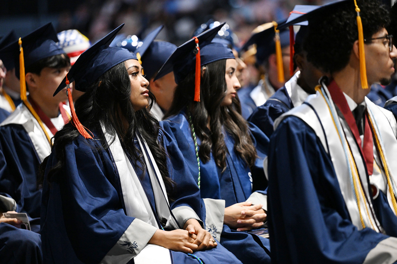 Female UNF graduates seated at commencement