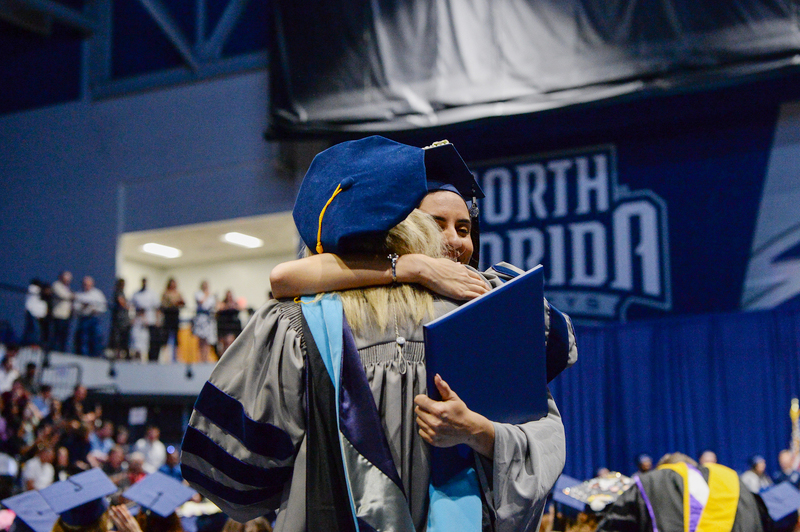 UNF graduate hugging a professor at commencement