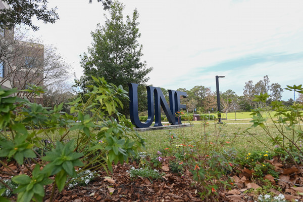 UNF campus landscape with UNF letters in the background
