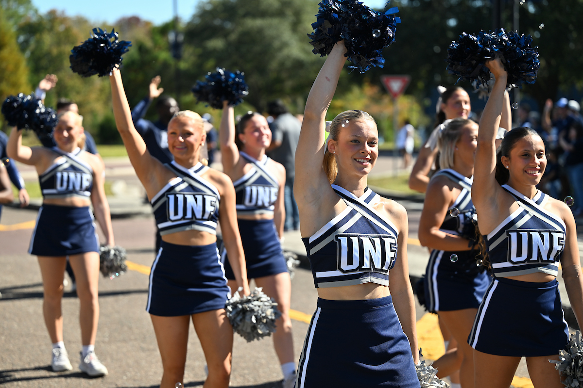 UNF cheerleaders walking in a parade