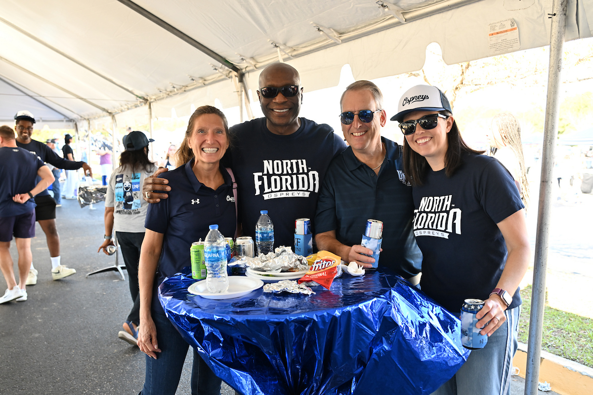 UNF employees socializing at a Homecoming event
