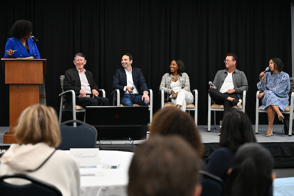 Event panelists seated on stage