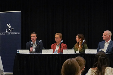 Event panelists seated on stage