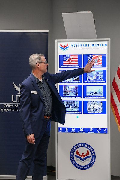 Gentleman using the Veterans Museum Kiosk at UNF
