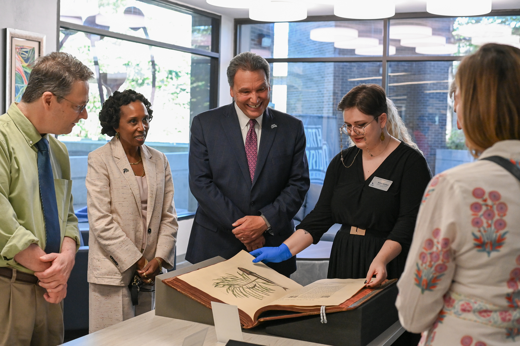 People looking at a book in the Allen Lastinger Center for Florida History