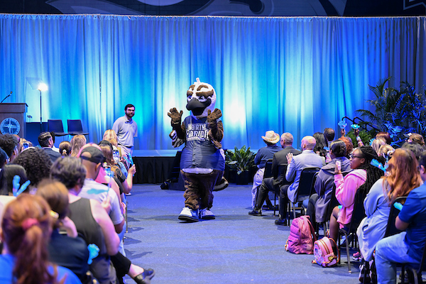 Ozzie waving to the audience at UNF Convocation 2025