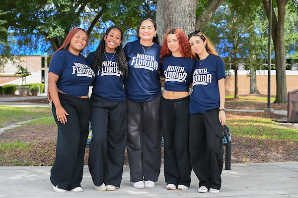 Five female UNF students standing and posing together