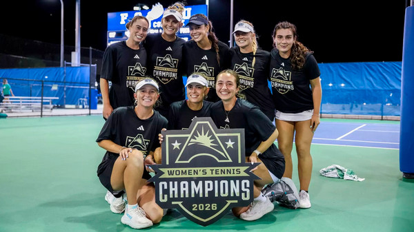 UNF Women's Tennis team posing with ASUN Championship poster