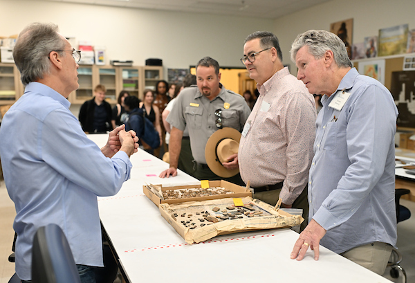 UNF professor speaking to guest at a archaeology lab dedication event