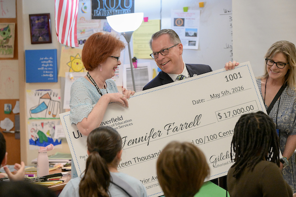 School teacher presented with a check