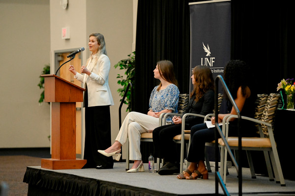 Woman speaking on stage at the 2026 Taylor Leadership Institute Leadership Awards and Taylor Talks