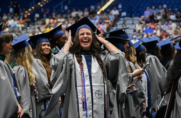 UNF grad school students at commencement wearing caps and gowns