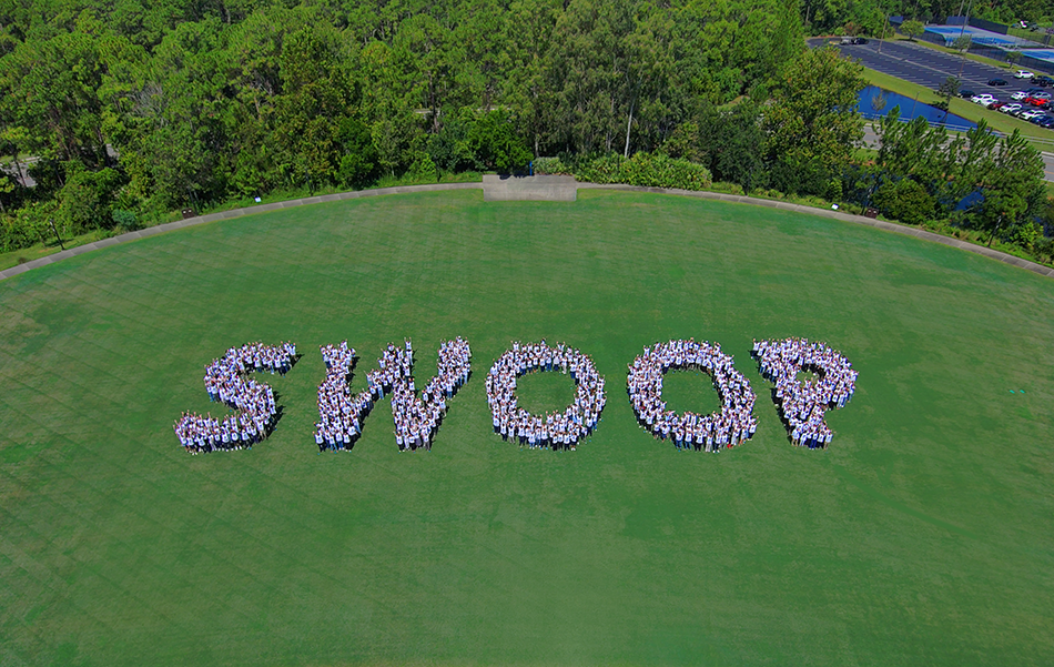 Aerial view of UNF employees spelling Swoop at J.B. Coxwell Amphitheatre field