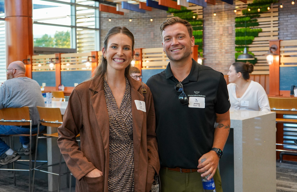 Male and female UNF alumni members at a campus event