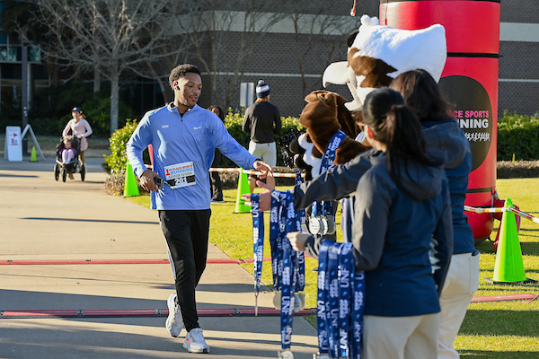 Runner receiving a ribbon at a race