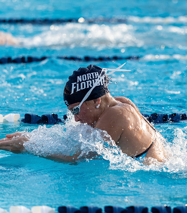 UNF swimmer swimming in a pool
