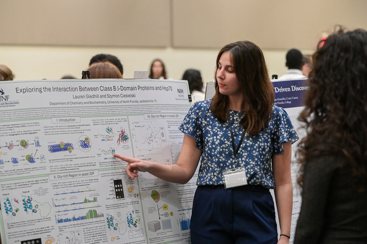 UNF student presenting a research poster at a conference