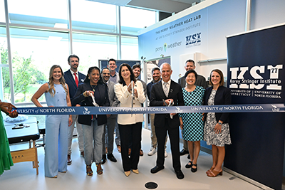 UNF Interim President Dr. Angela Garcia Falconetti, BCH faculty and KSI staff cutting blue ribbon