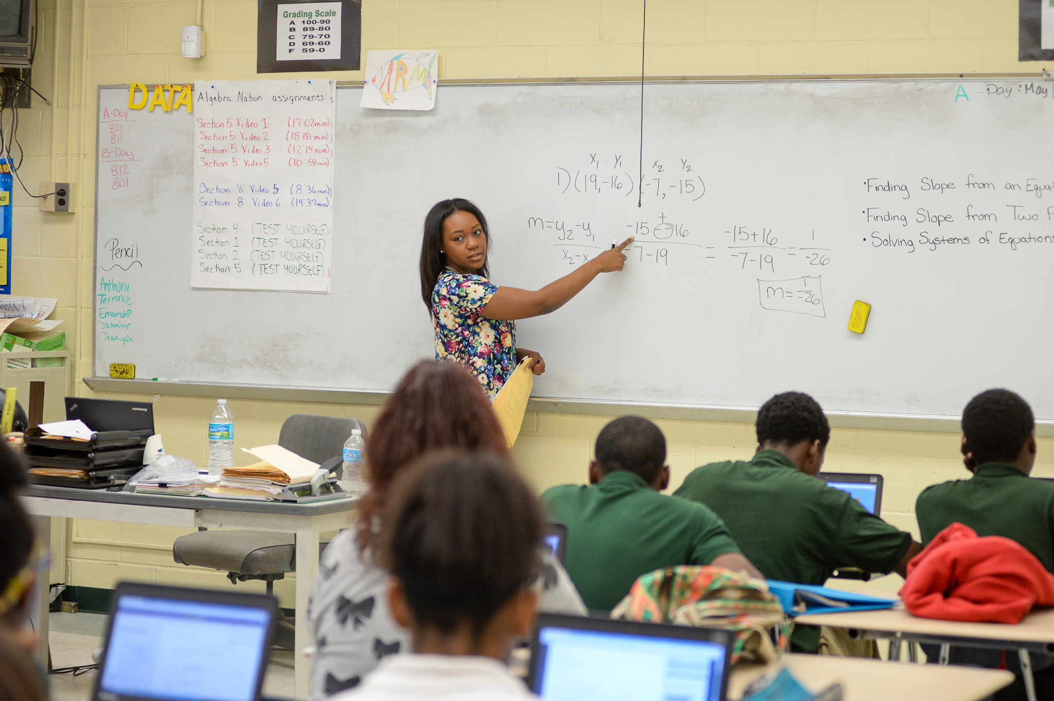 UNF student teaching math at a white board in front of students
