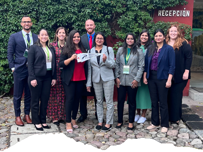 UNF students and faculty in business attire posing for a photo