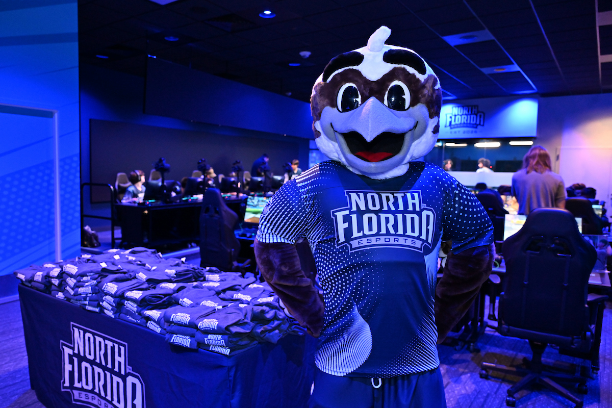 Ozzie the Mascot standing in the UNF Flight Deck