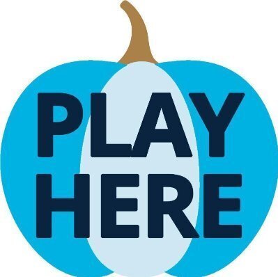 Multi-colored blue pumpkin with the words Play Here