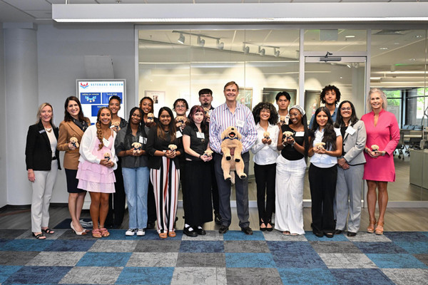 Dr. Paul Schilling standing with group of UNF staff and students