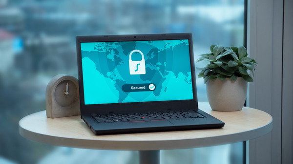 Laptop on a table with the screen showing a lock and the word secured